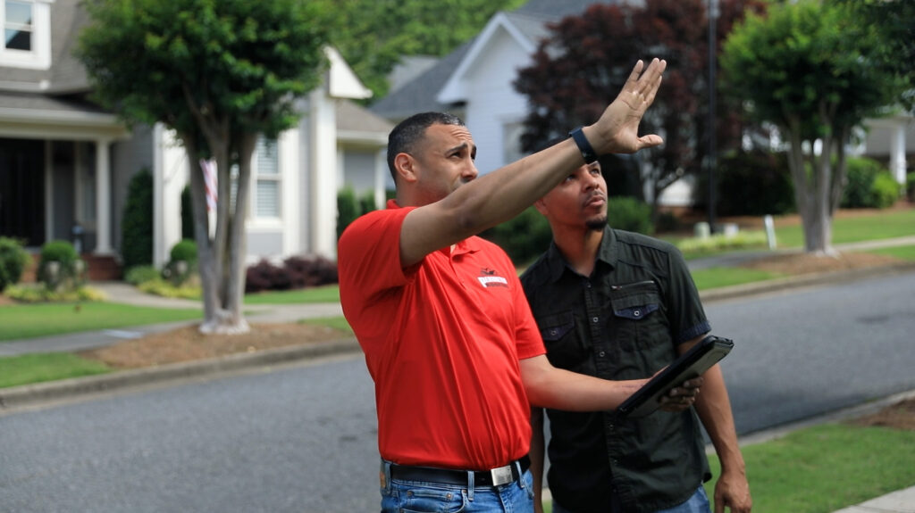 technician explaining the roof repair work to a customer